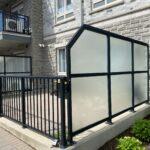 glass privacy divider and black aluminum railing