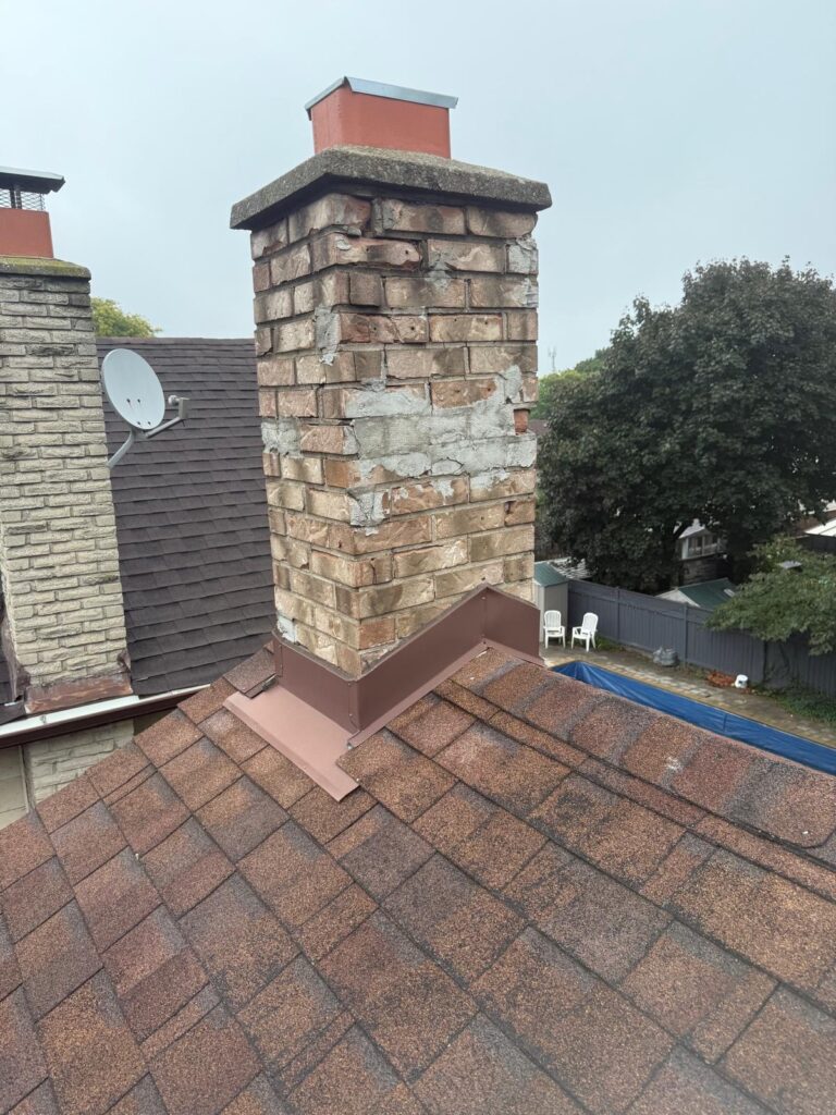 Old brick chimney in Toronto with cracked and missing mortar before repair