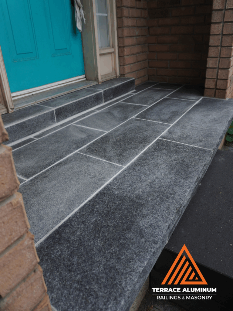 Front porch flagstone installed over existing concrete base with a premium natural stone finish.