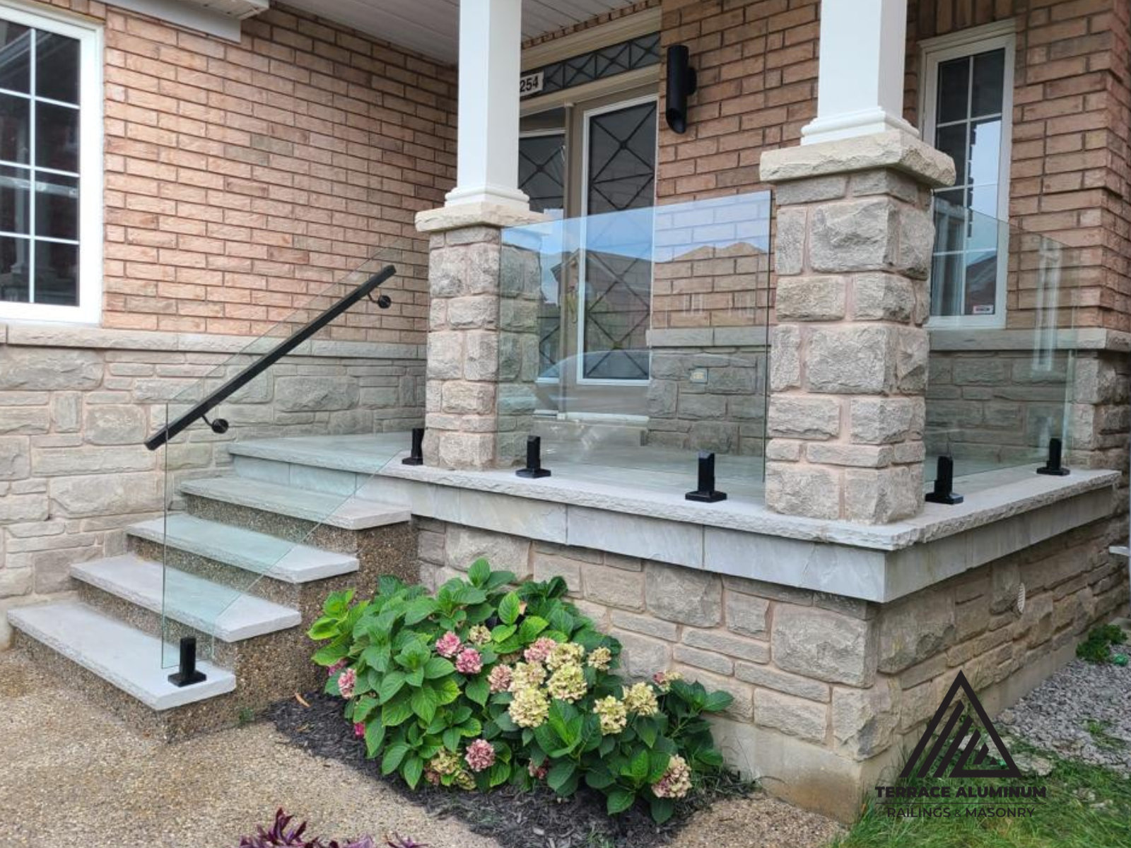 Custom Oakville flagstone steps with glass stair railing