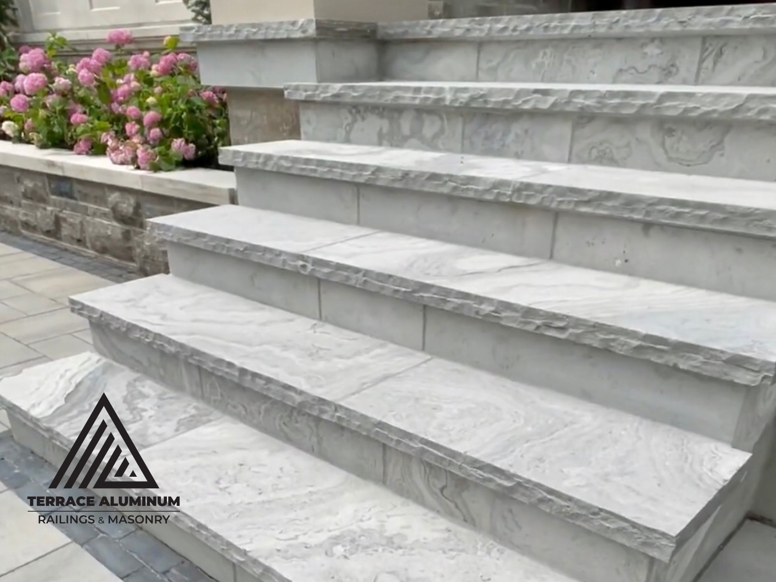 Masonry contractor installing natural flagstone steps in Oakville.