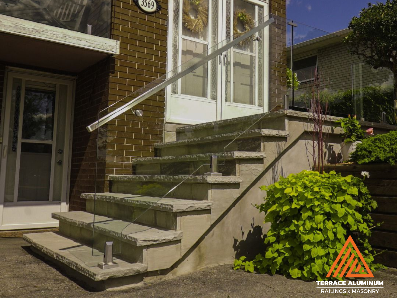 Flagstone patio with modern glass railing in Oakville