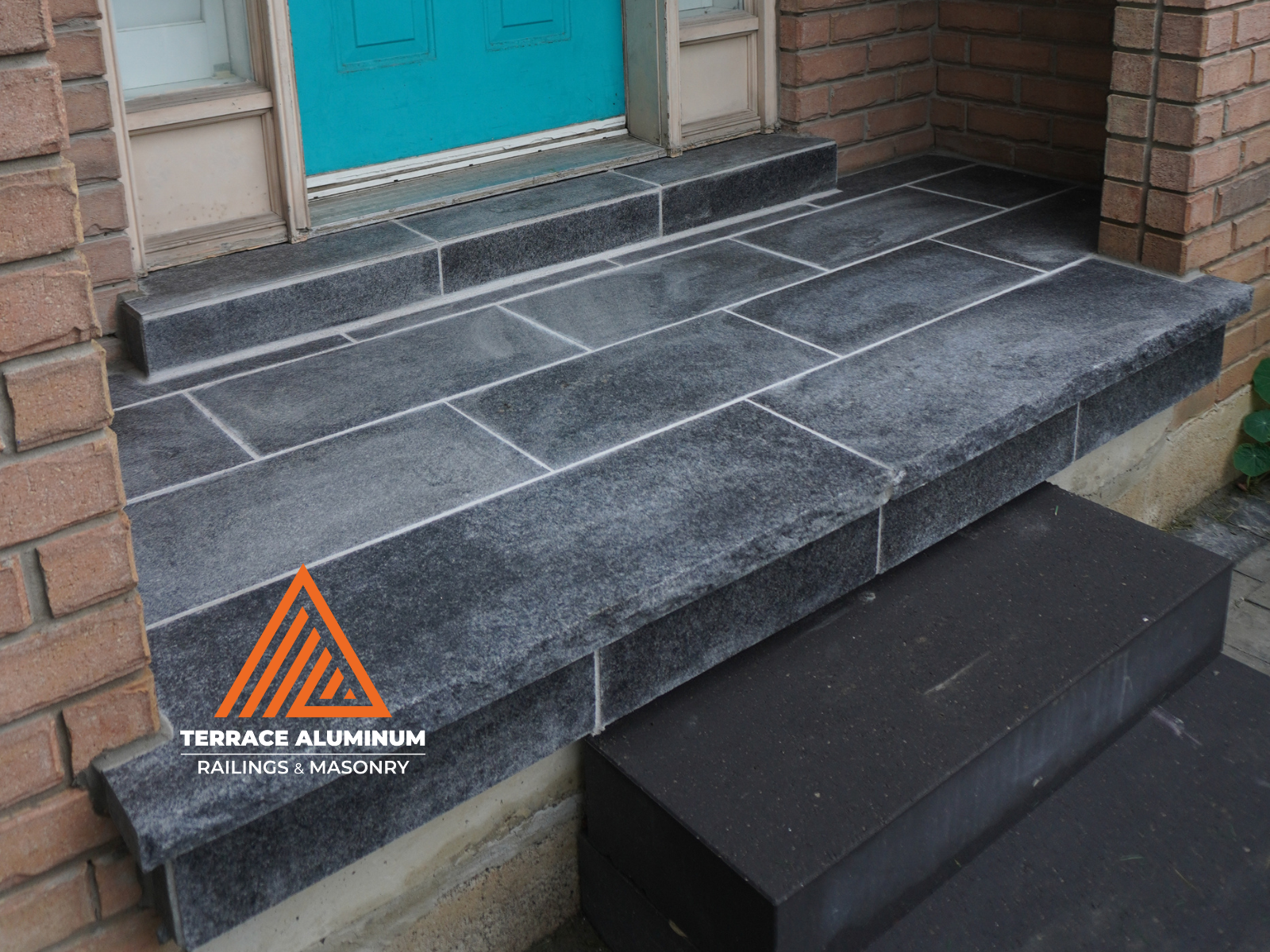 Flagstone patio and front porch installation in Oakville home.