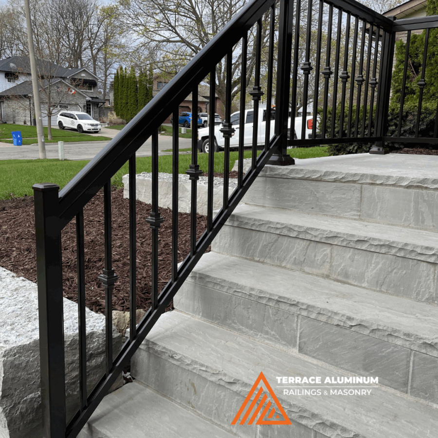 Flagstone steps and black aluminum railing installation in Oakville entrance.