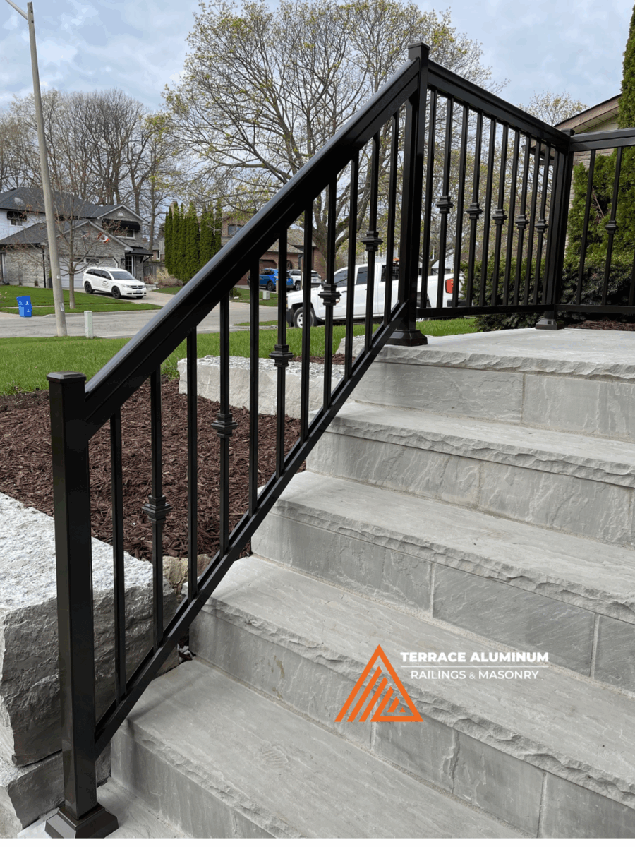 Flagstone steps and black aluminum railing installation in Oakville entrance.