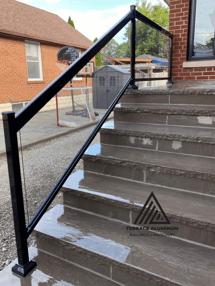 Modern Oakville patio with irregular flagstone and black glass railing