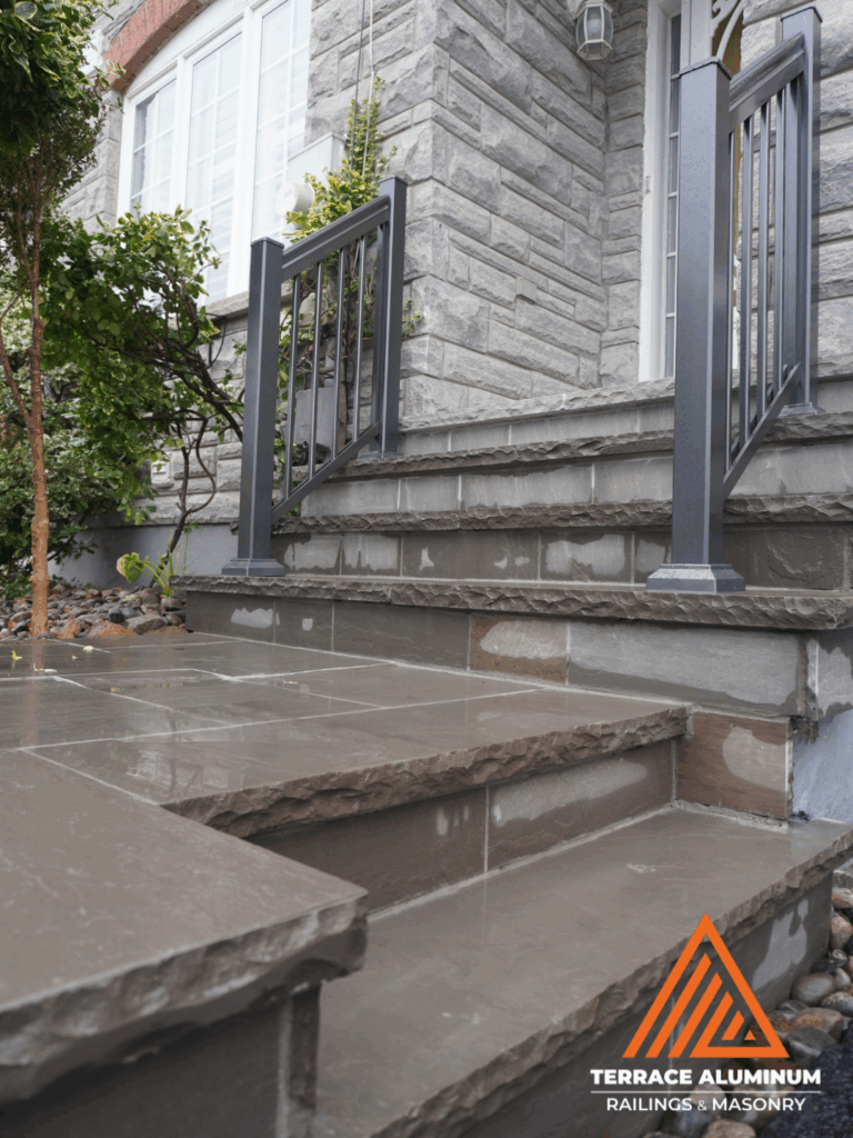 alt="Flagstone porch installation over existing concrete surface in Toronto showing natural stone detail and smooth joints."
