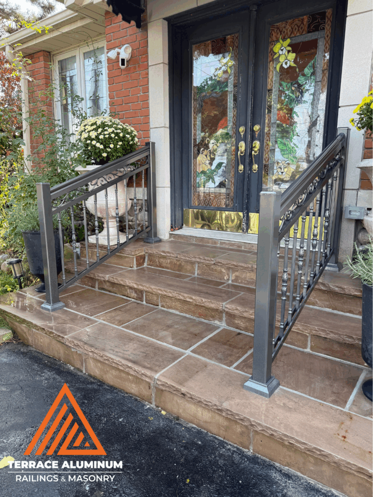 Front entrance in Oakville with flagstone stairs and black aluminum porch railings.
