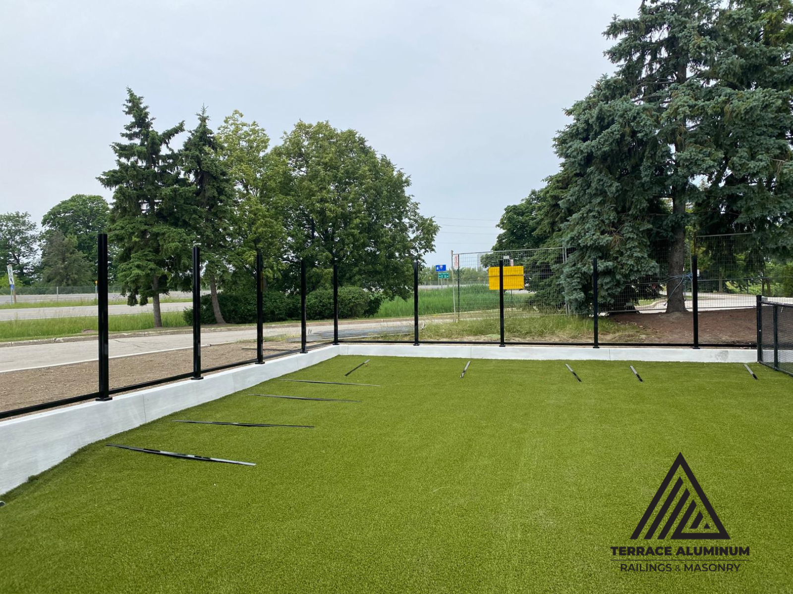 Contractors installing composite fence panels and posts on-site in Toronto