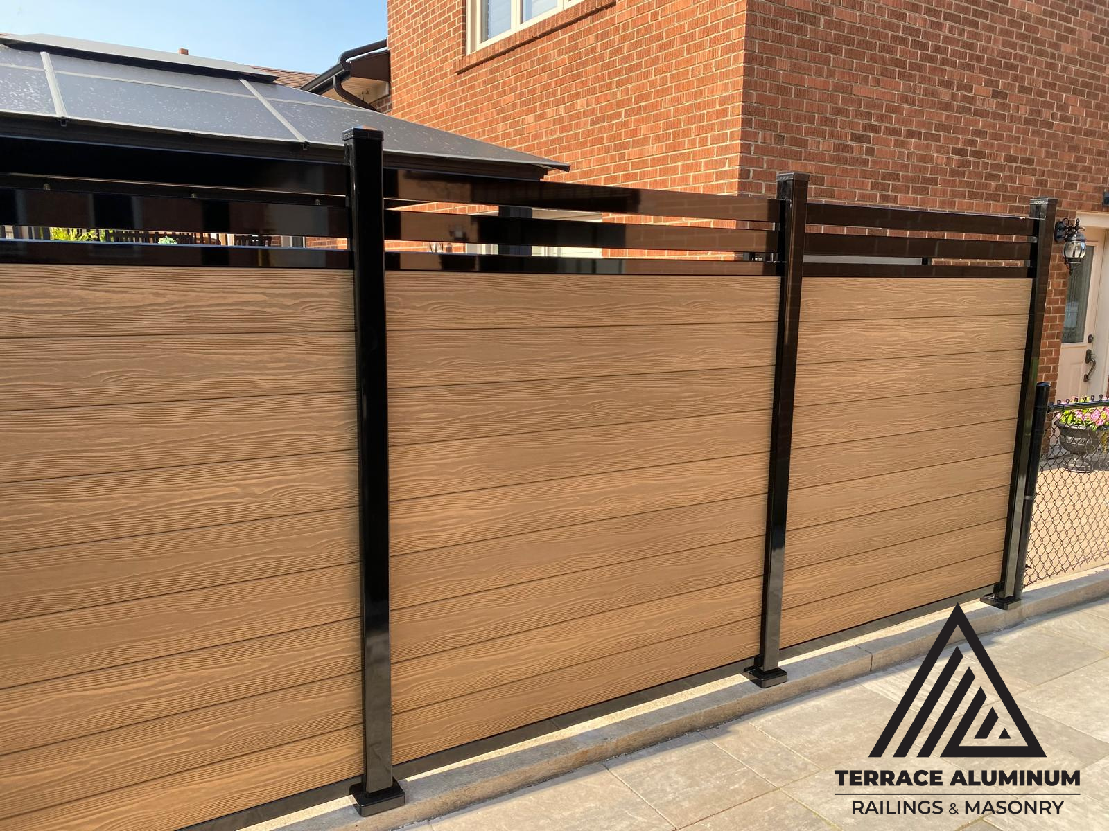 Modern composite fencing with gray boards and aluminum posts in Toronto