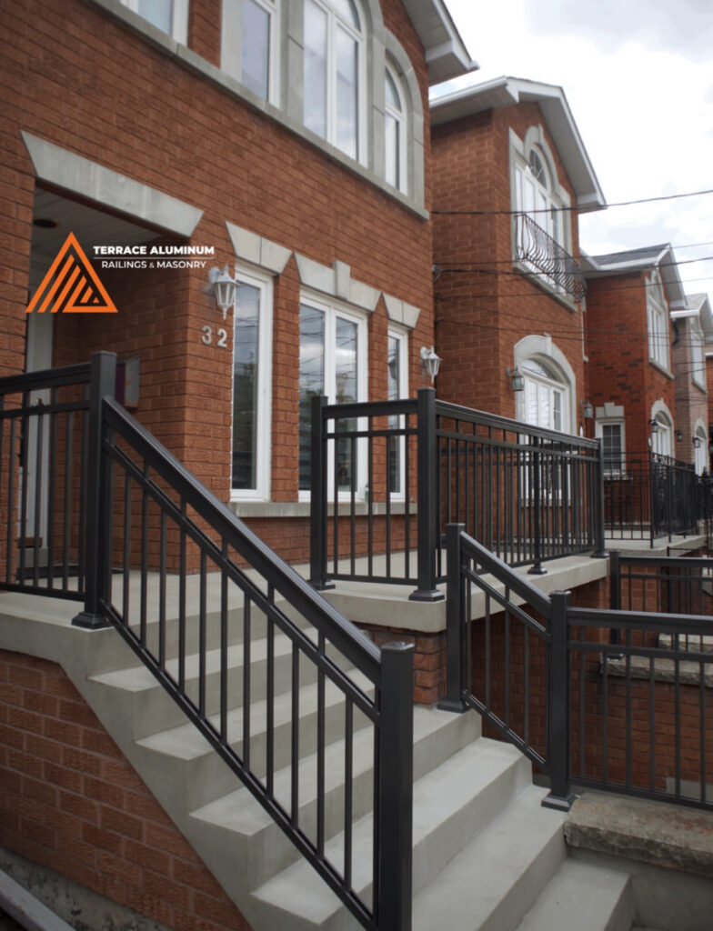 Concrete front porch with aluminum railings in Toronto by Terrace Aluminum Railings & Masonry.