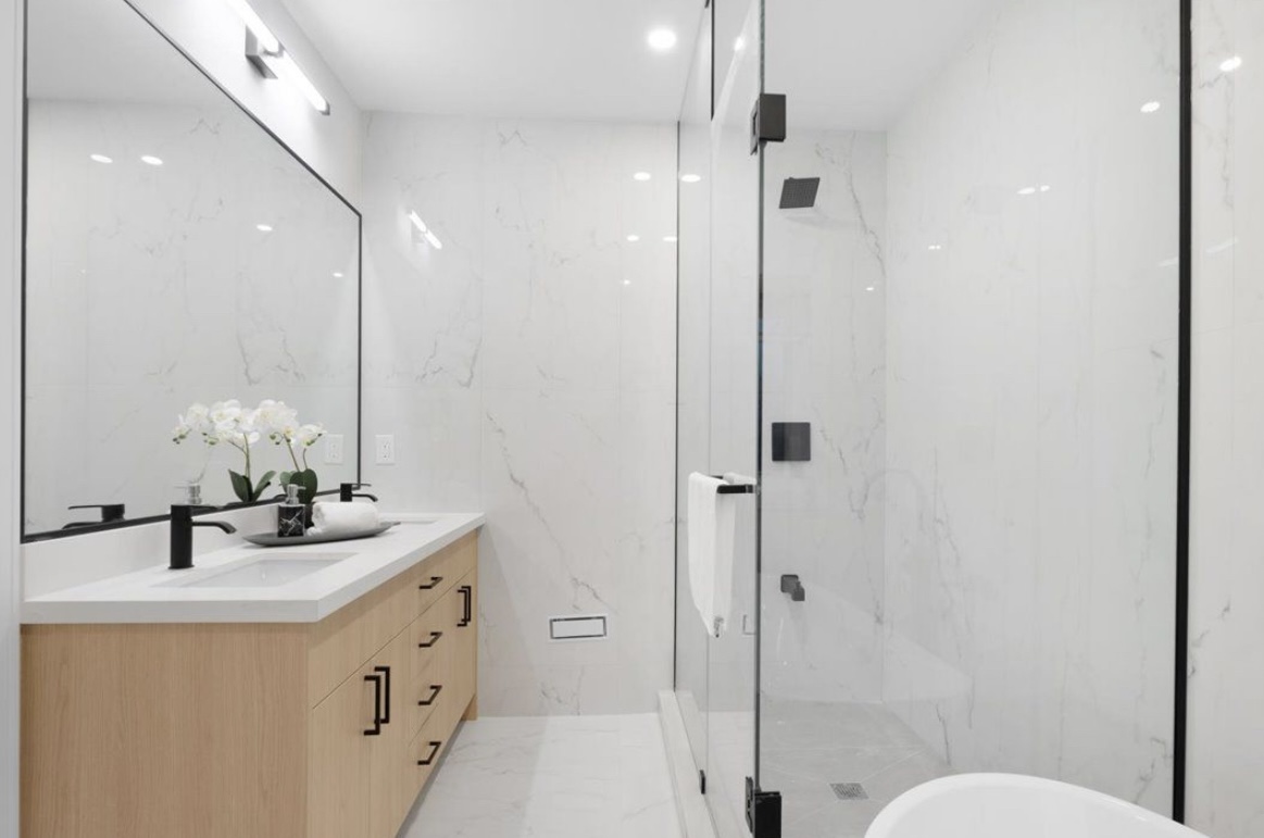 Frameless shower glass enclosure with stainless steel hardware in Toronto