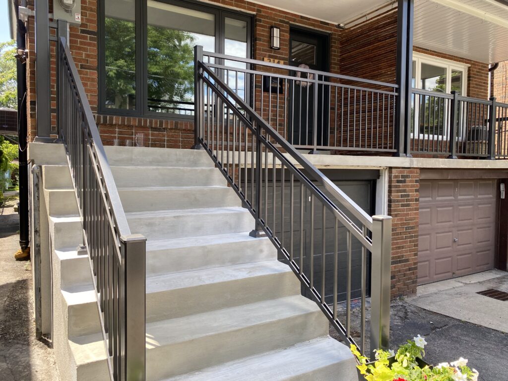 Parging and aluminum railings on a front porch in Toronto by Terrace Aluminum Railings & Masonry.