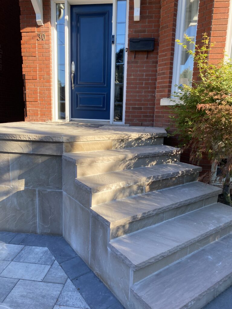 New flagstone porch in Toronto with fresh masonry and modern front entrance