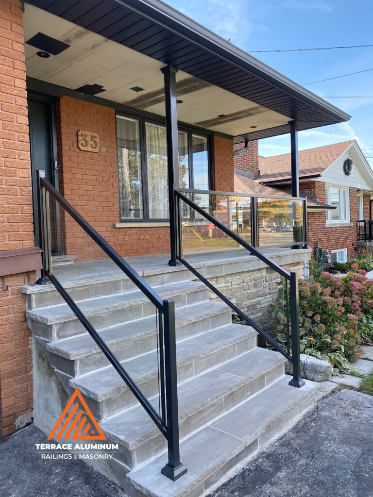 New flagstone porch with aluminum glass railings and aluminum columns in Toronto.