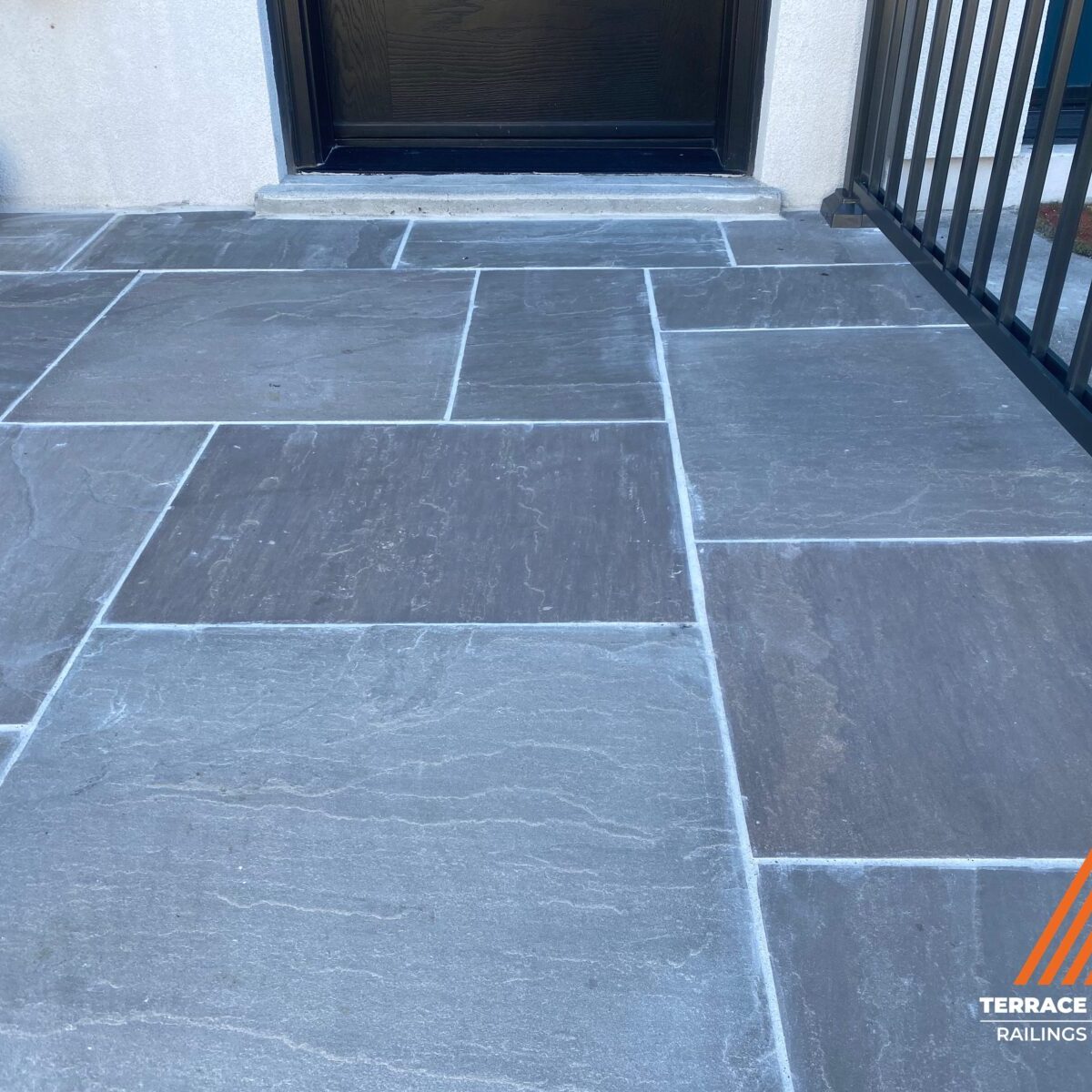 Front porch repair with flagstone in Toronto by Terrace Aluminum Railings & Masonry.