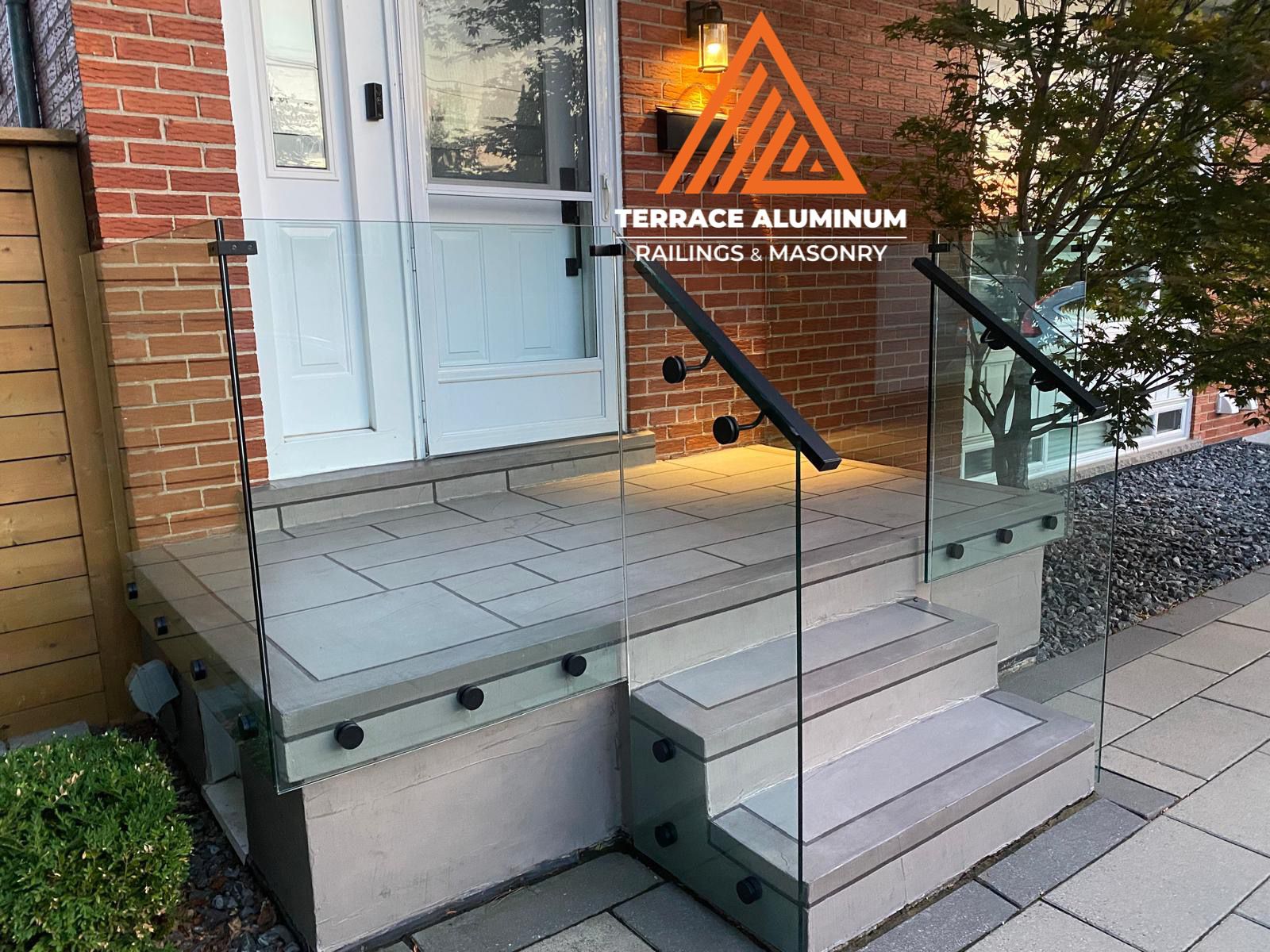 frameless glass railings on a resurfaced front porch in Toronto