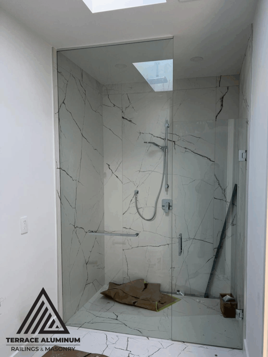 Frameless shower glass enclosure in modern bathroom