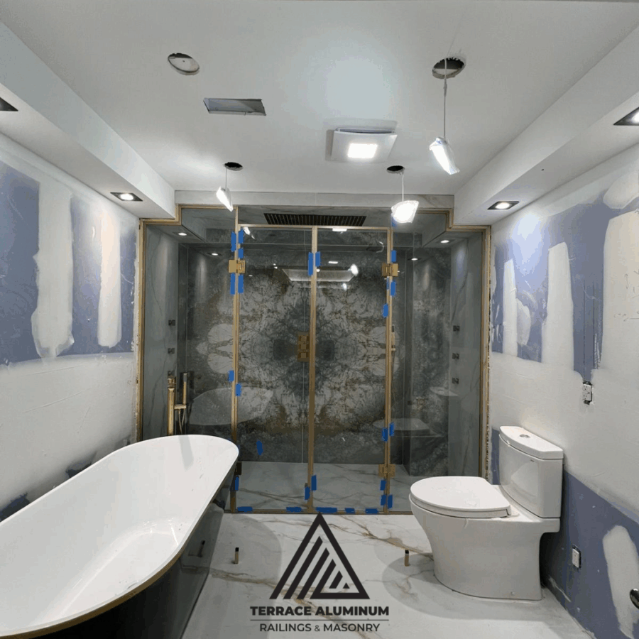 Modern frameless shower glass enclosure installed in a contemporary Toronto bathroom