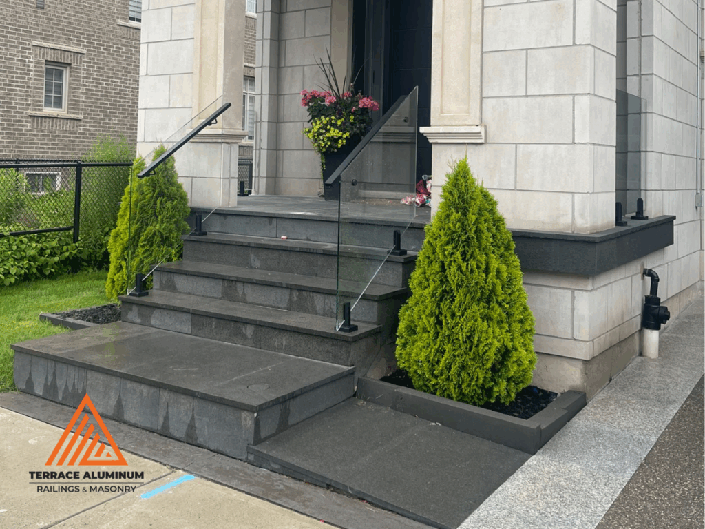 Frameless glass railings on a modern front porch in Toronto by Terrace Aluminum Railings & Masonry.