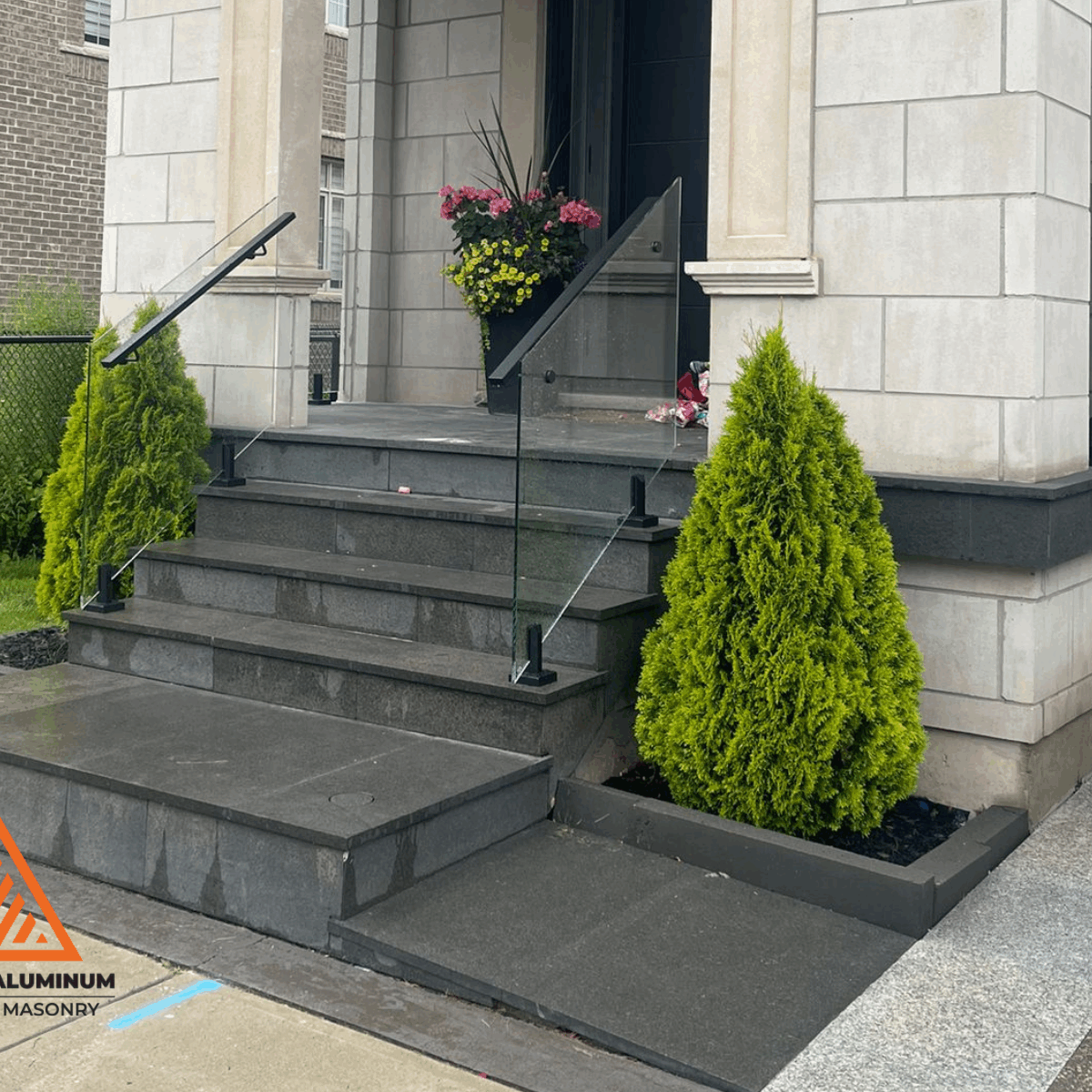 Frameless glass railings on a modern front porch in Toronto by Terrace Aluminum Railings & Masonry.