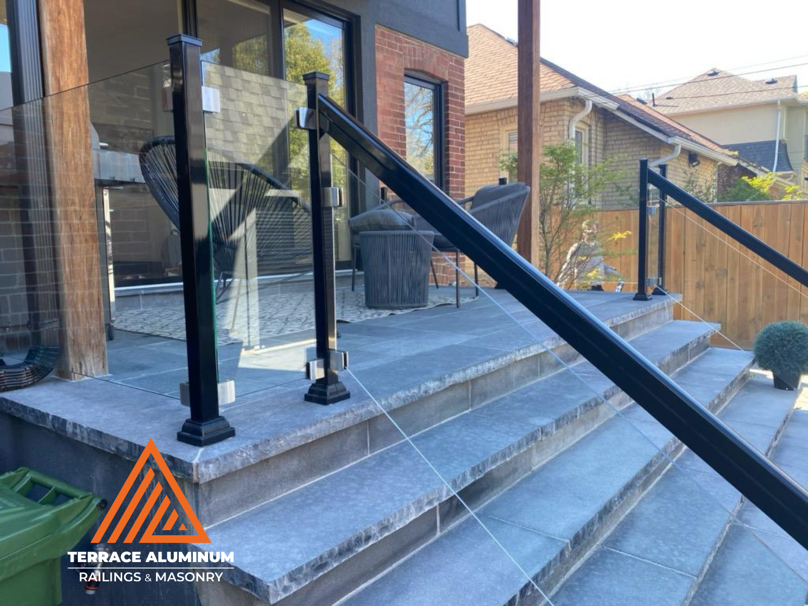 "Frameless glass railing with aluminum posts installed in Toronto by Terrace Aluminum Railings, featuring 12mm tempered glass panels for a clean and modern look."