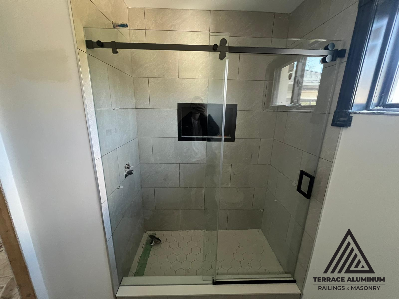Frameless glass shower door with minimalist