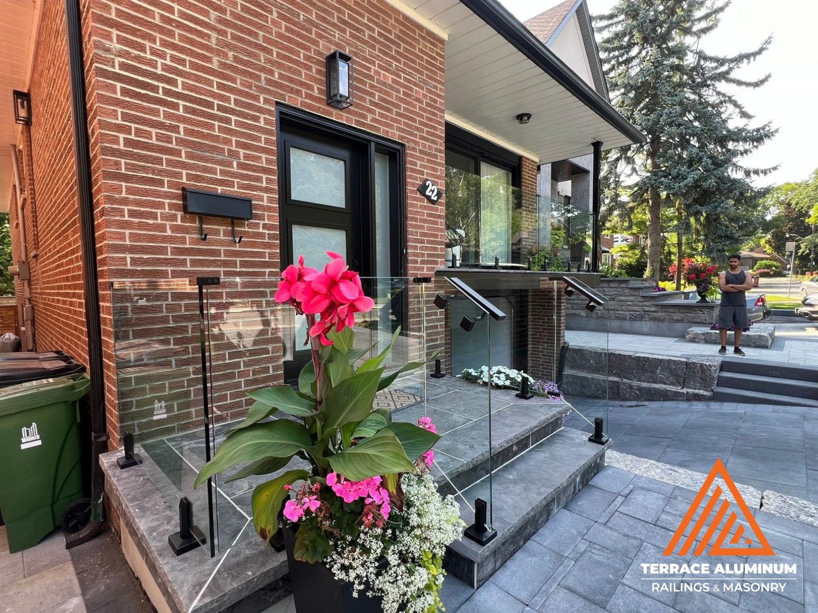 alt="Frameless glass railing on a porch in Toronto installed by Terrace Aluminum Railings, featuring 12mm tempered glass panels and stainless steel hardware for a high-end modern look."