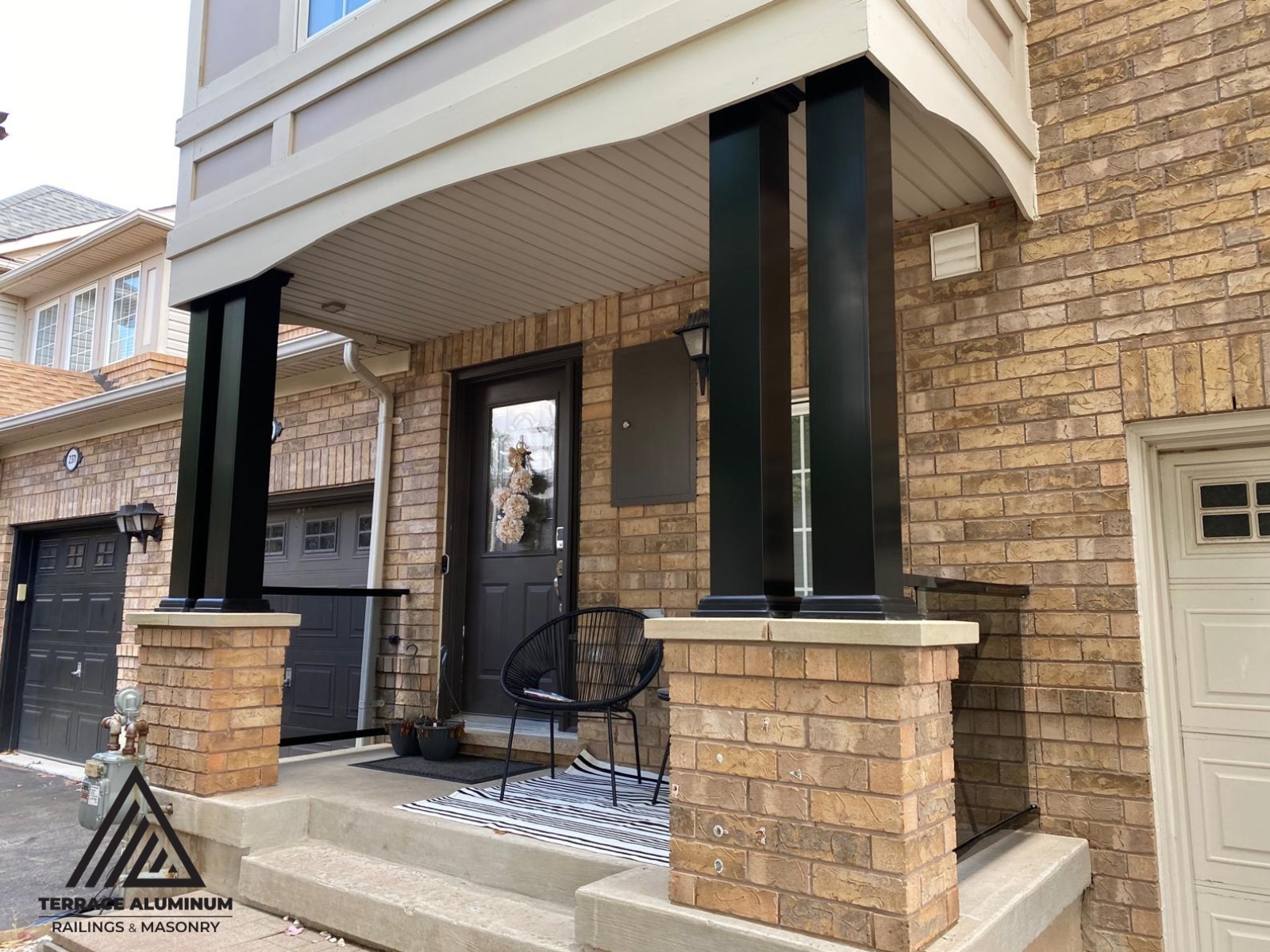 alt="Tinted glass railing with aluminum posts and aluminum columns on a front porch in Toronto installed by Terrace Aluminum Railings, featuring bronze tempered glass panels for a stylish modern appearance."