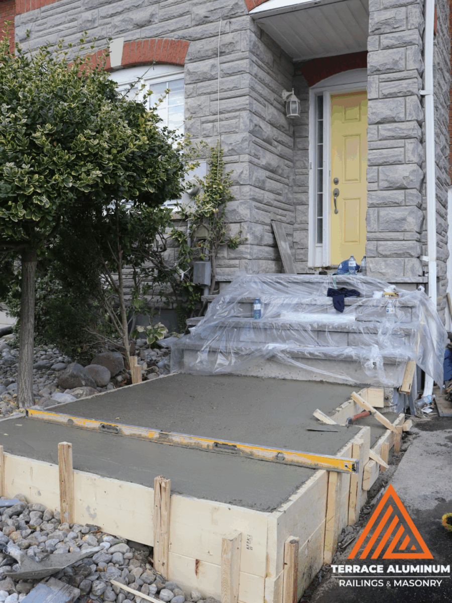 Professional concrete contractor working on Toronto porch – Terrace Aluminum Railings & Masonry