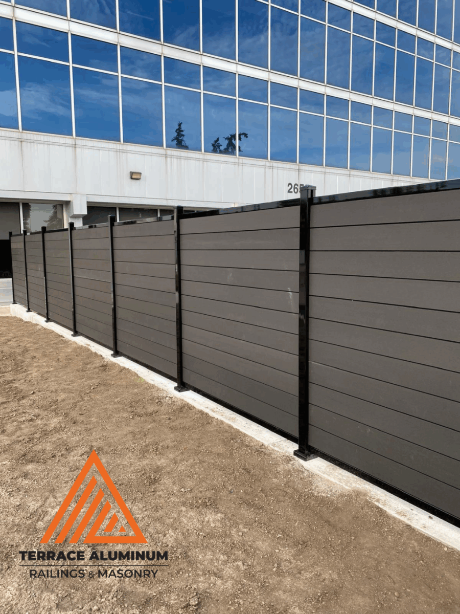 Installing composite fence panels with aluminum posts in Toronto backyard