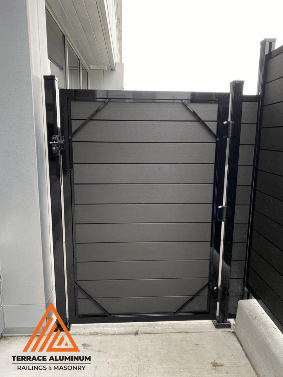 Composite fence door with matching panels and black aluminum frame in Toronto