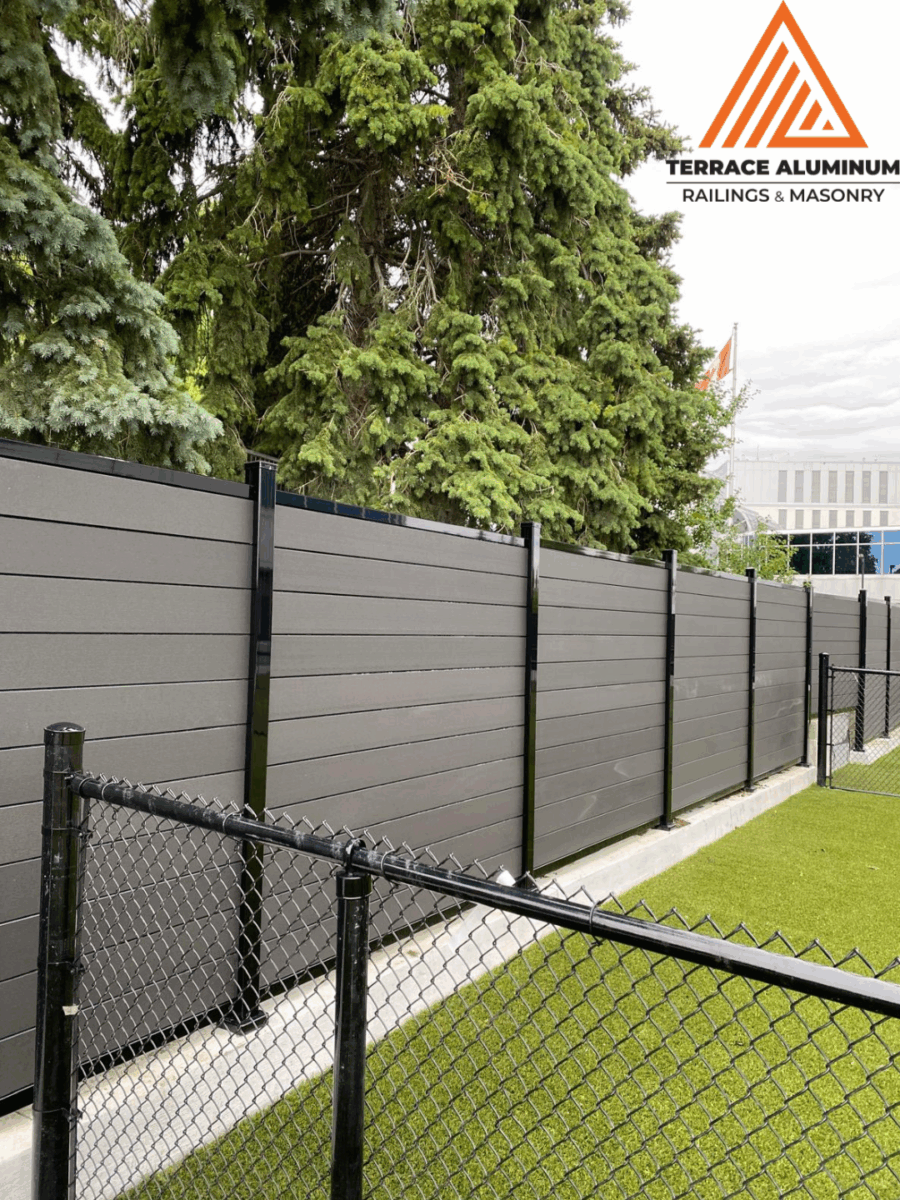 Modern backyard with composite fence panels and aluminum posts in Toronto