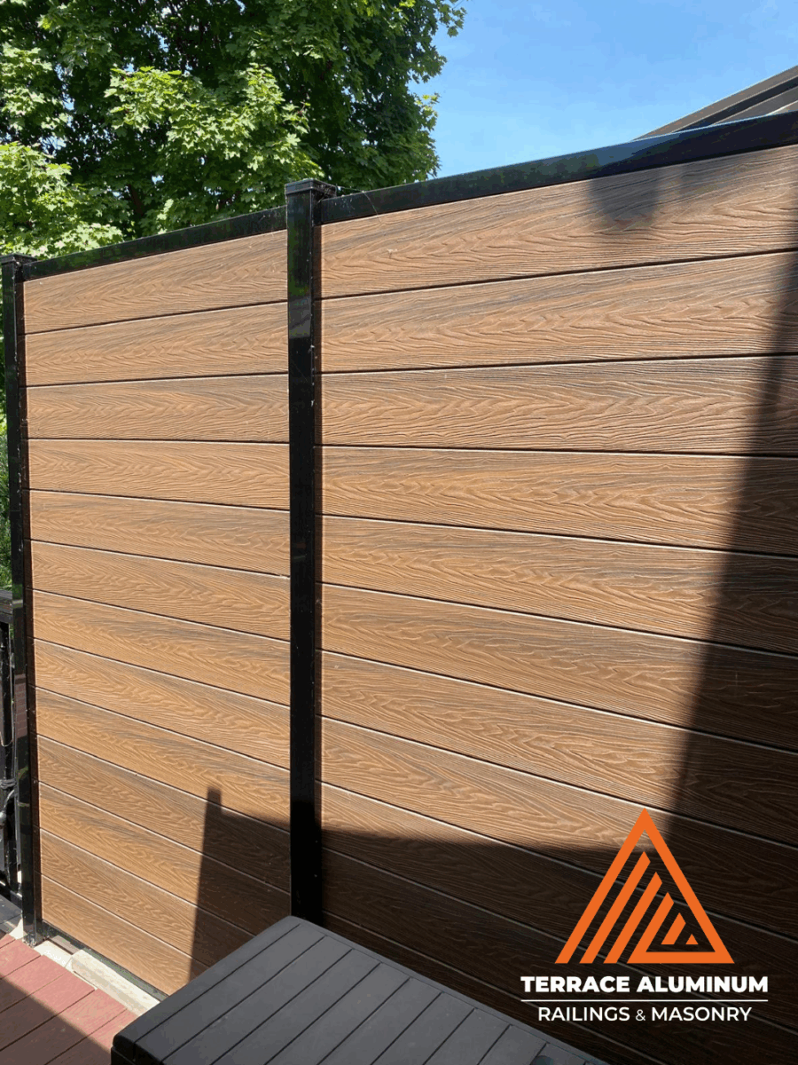 Horizontal slatted composite fence with dark grey boards in Toronto