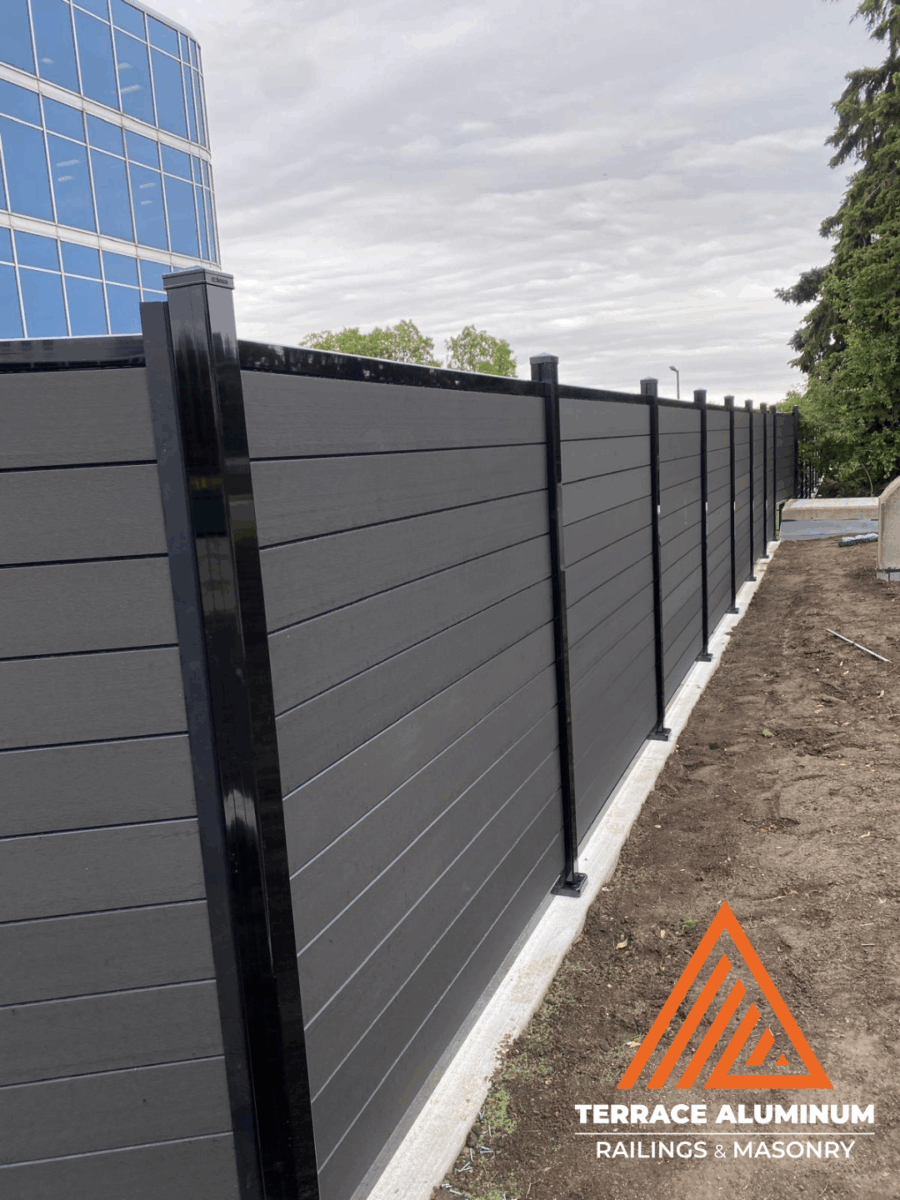 Close-up of composite fence boards with wood-grain texture