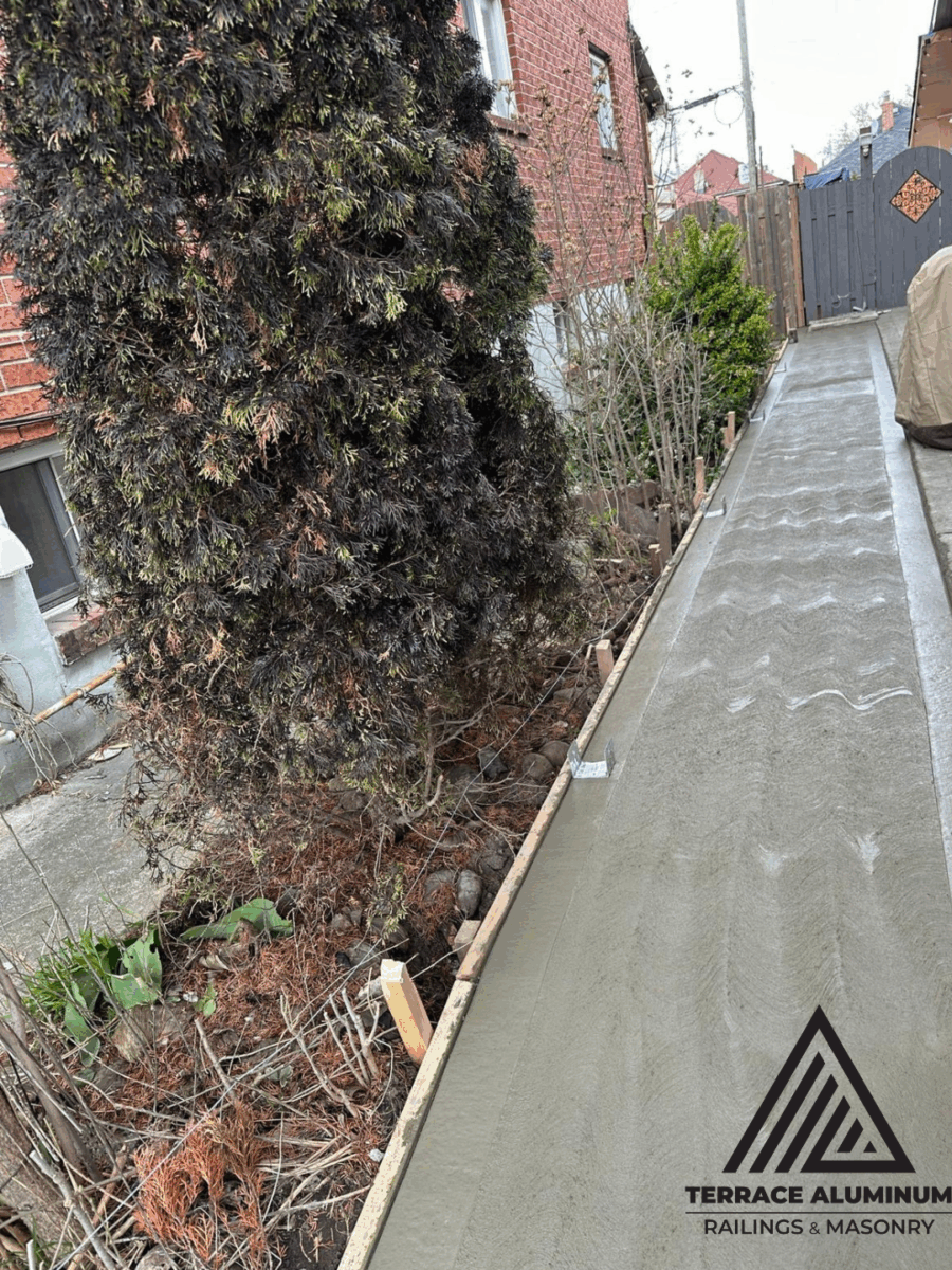 Freshly poured concrete sidewalk along residential property in Toronto