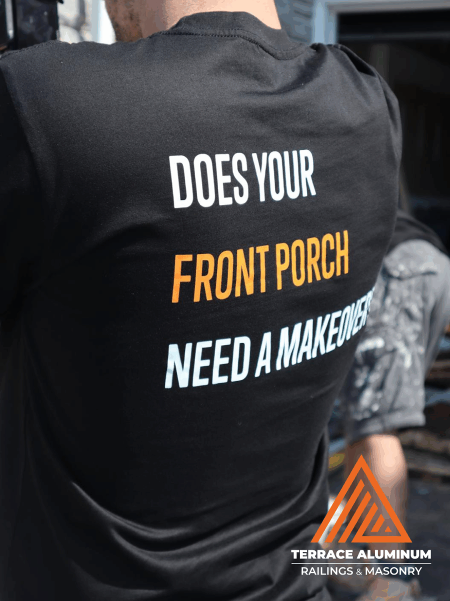Person taking a photo of a beautiful renovated front porch with the phrase “Does Your Front Porch Need a Makeover” by Terrace Aluminum Railings & Masonry.