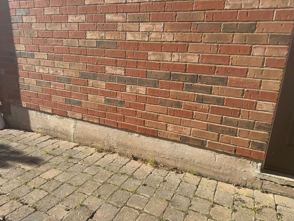 alt="Exterior brick repair in Hamilton with new mortar joints and rebuilt sections blending perfectly with the home’s original brick"