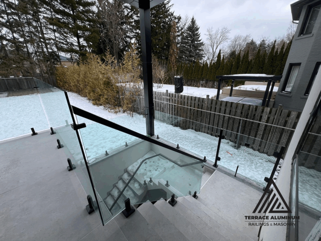 alt="Modern staircase glass handrail with tempered glass panels and stainless steel hardware installed in Toronto home"