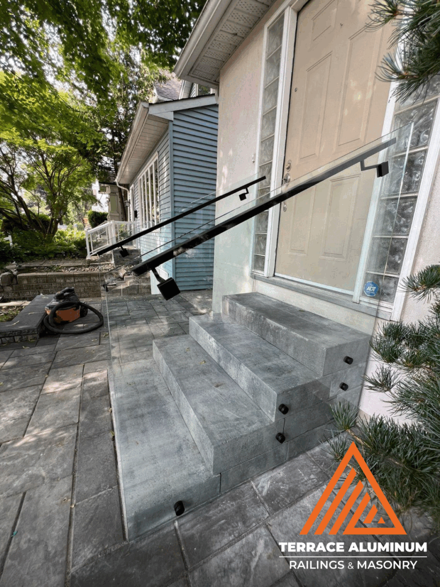 alt="Modern staircase glass handrail with clear tempered glass panels in Toronto"