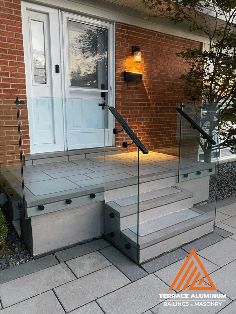 Frameless glass railing system on a front porch in Toronto installed by Terrace Aluminum Railings & Masonry.