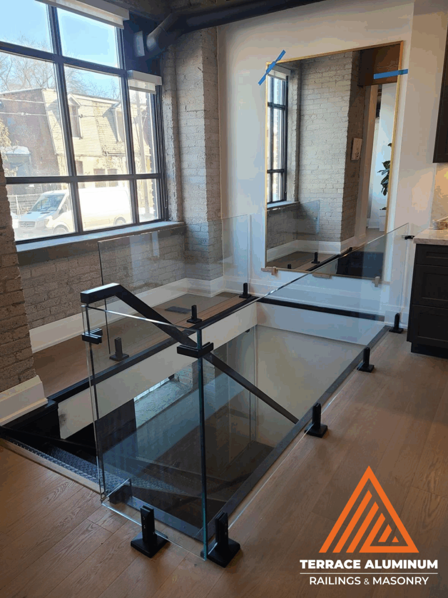 alt="Interior frameless staircase glass handrail with clear tempered glass panels installed in Toronto home"