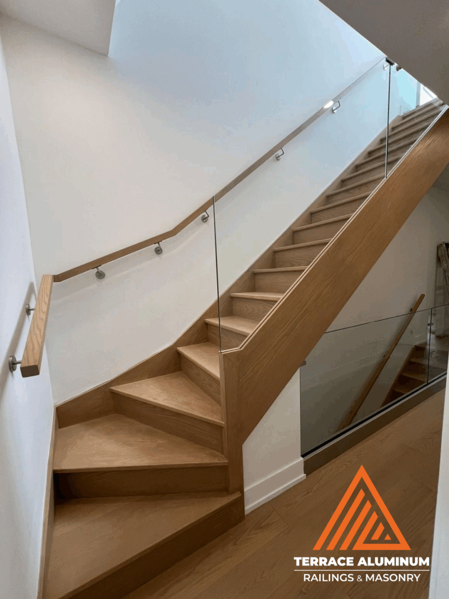 alt="Interior staircase glass handrail with tempered glass panels and minimalist hardware installed in Toronto"