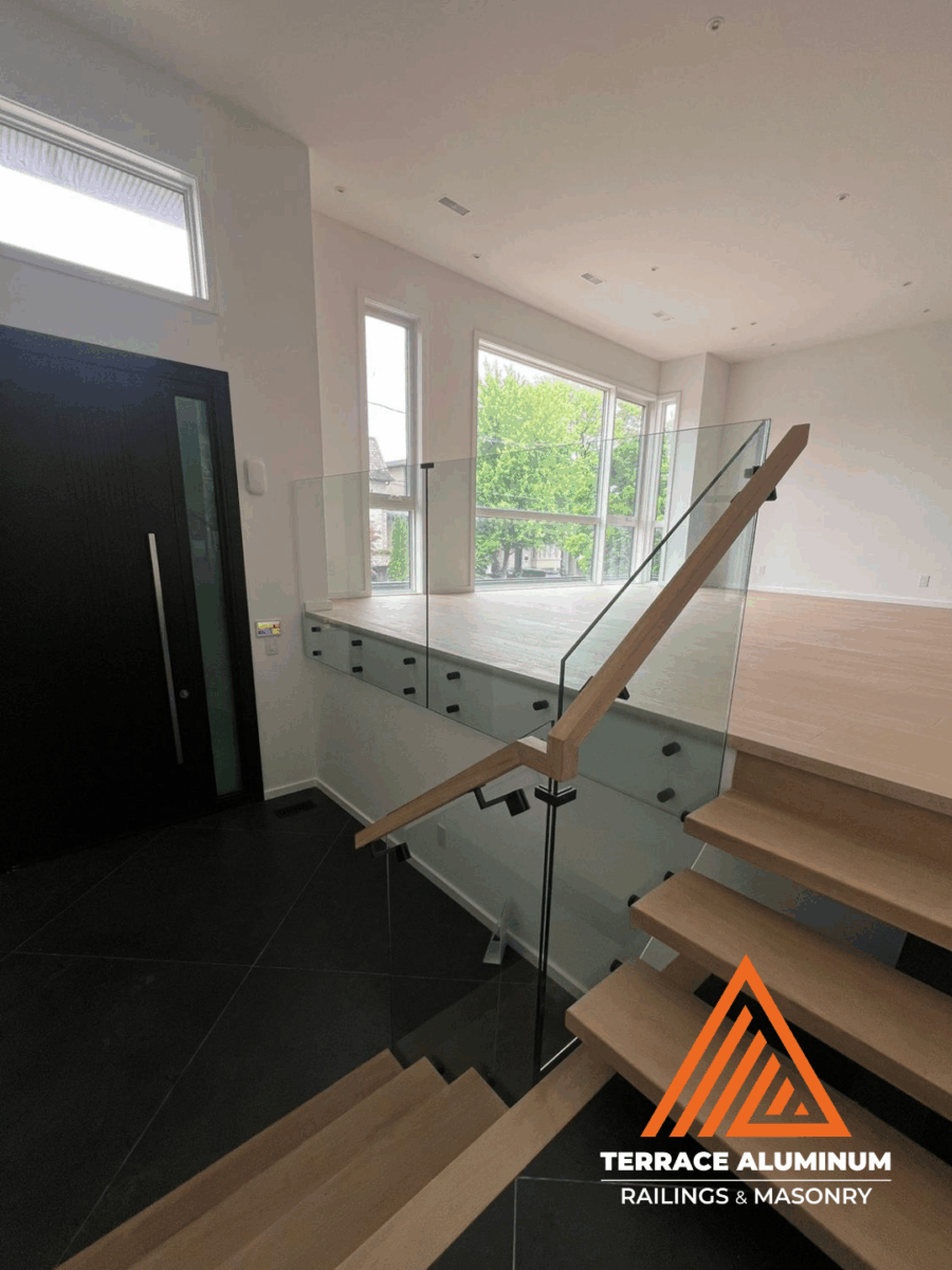 alt="Modern interior staircase glass handrail installed with clear tempered glass panels in Toronto"