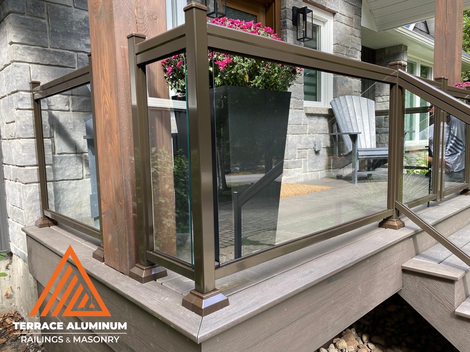 alt="Framed aluminum glass railing with clear glass panels installed in Toronto by Terrace Aluminum Railings, offering modern style and durability for decks and balconies."