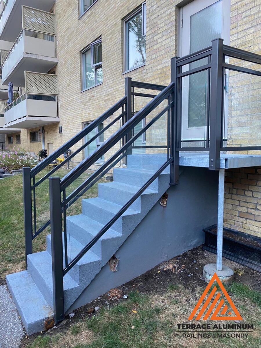 alt="Staircase glass handrail installation in Toronto with modern tempered glass railing design"