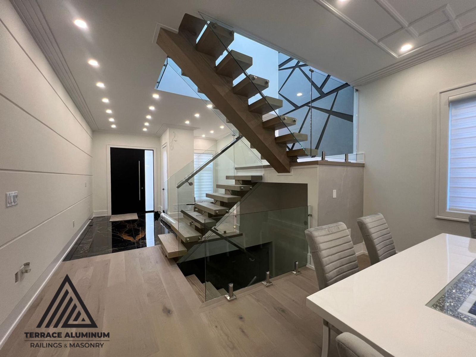 alt="Interior staircase glass handrail with tempered glass panels installed in a modern Toronto home"