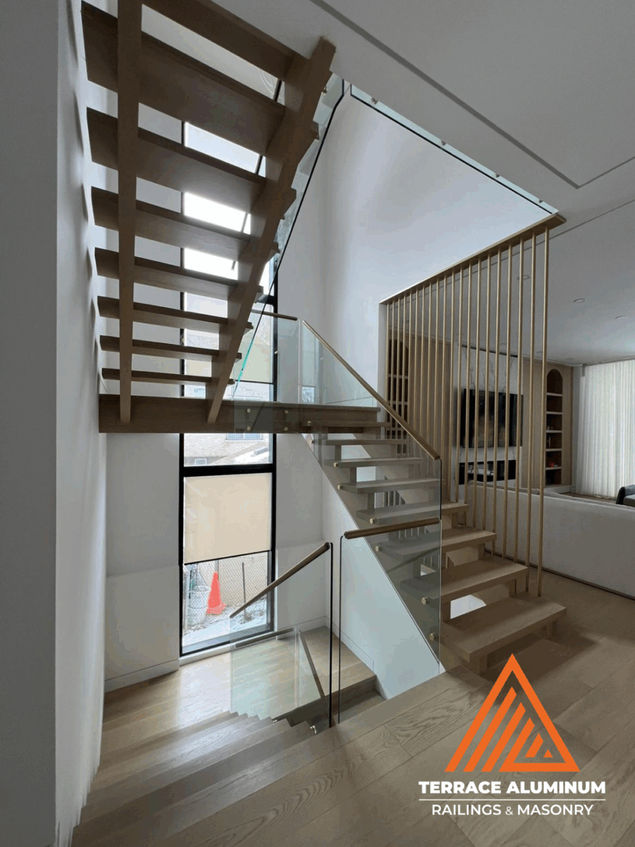 Frameless glass staircase railing installed with minimal hardware and smooth edges