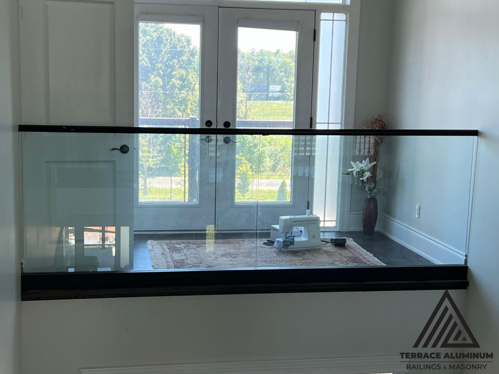 Custom indoor glass railing with tailored measurements and polished edges