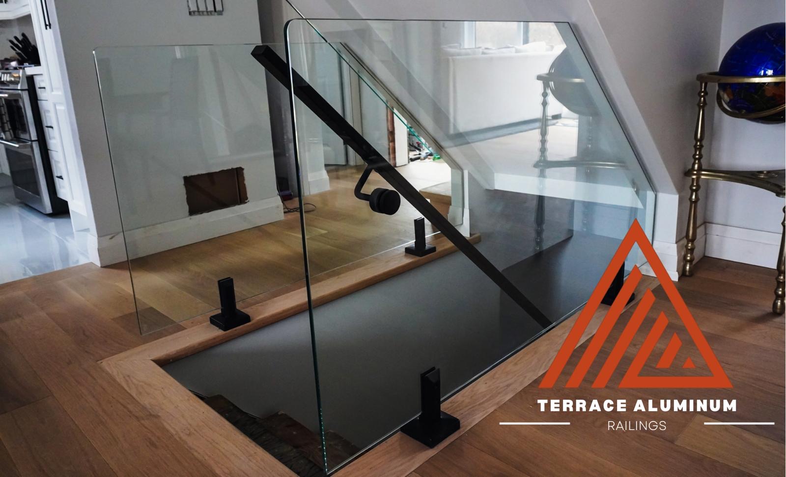 Interior glass railings Hamilton with frameless glass railings along a bright stairwell in a modern home